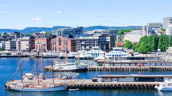 A port with boats docked near buildings and trees