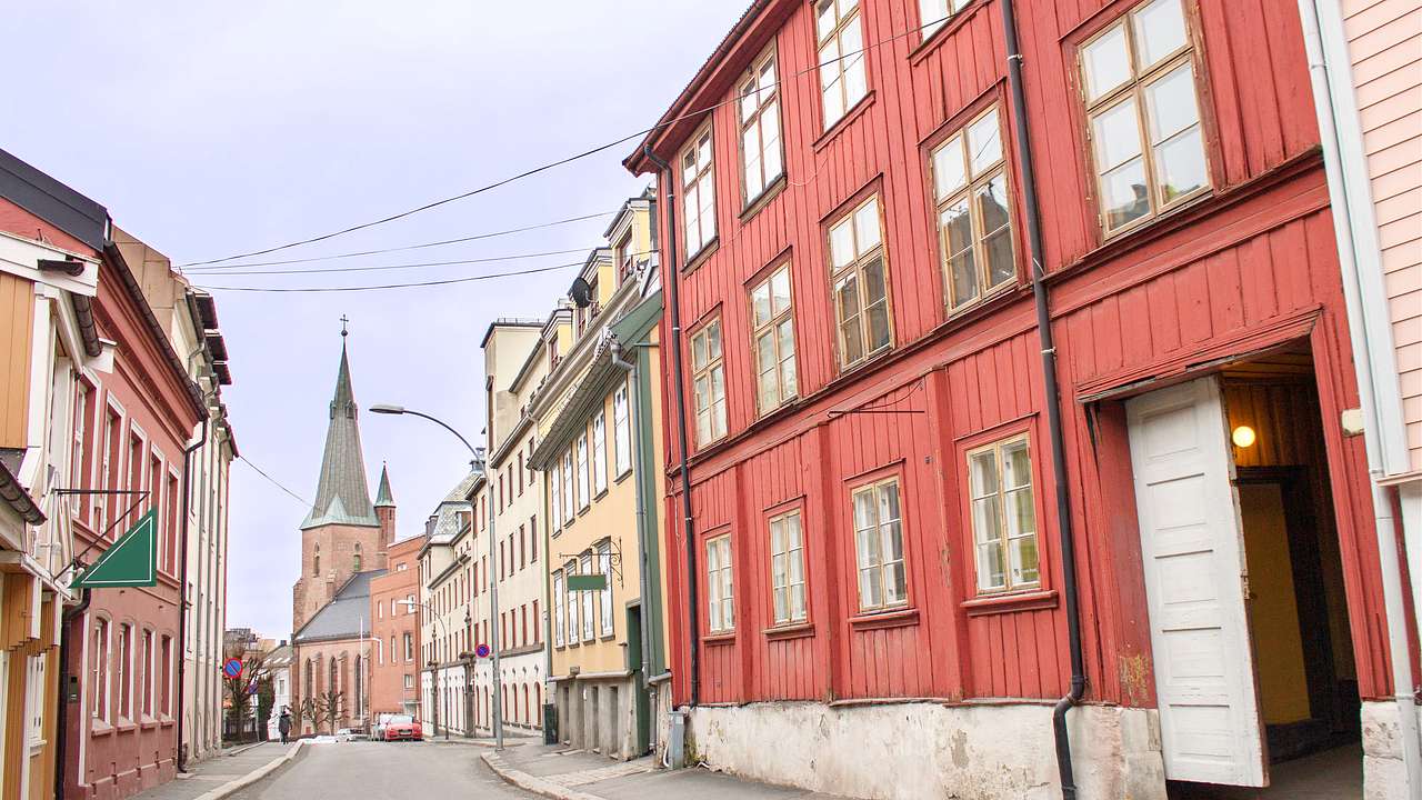 An empty alley surrounded by old colorful buildings