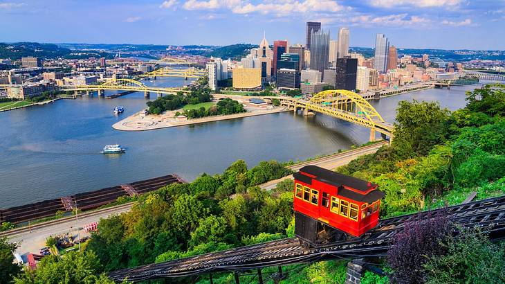 A city with yellow bridges across a body of water and a red and black incline