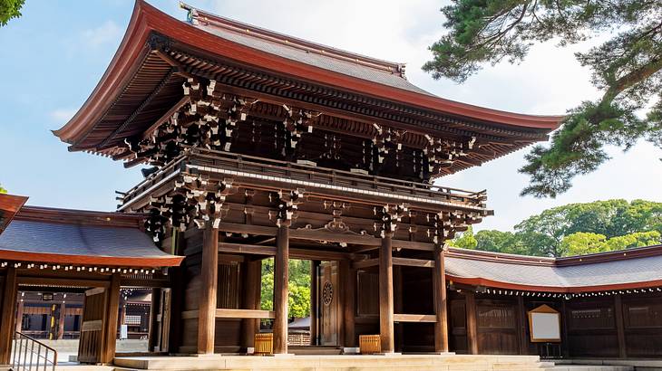 A Shinto shrine surrounded by trees on a sunny day