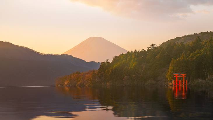 A red structure on the right side of a water area with mountains at the pack