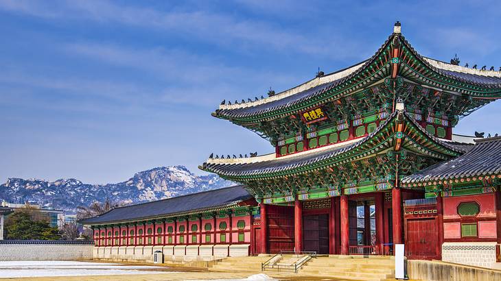 A grand colorful palace with a mountain range at the back; on a nice day