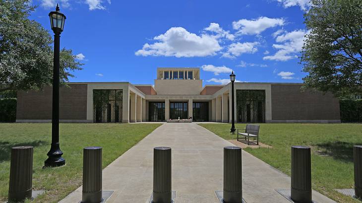 A building with a lawn and a walkway in front