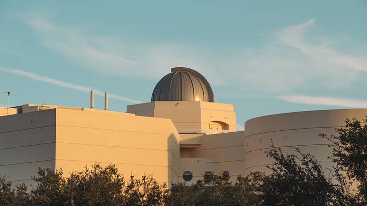 Rearview of a building with a dome-shaped roof during sunset