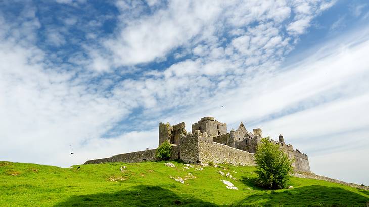 A medieval building complex, on a green hill, on a nice day A medieval building complex, on a green hill, on a nice day