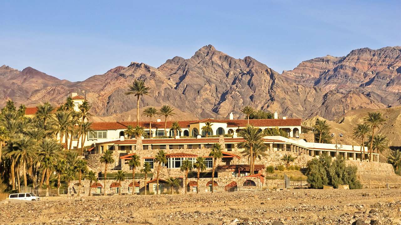 A building in a desert with mountains in the background