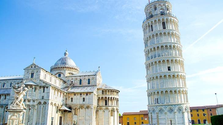 Leaning Tower of Pisa beside the Pisa Cathedral under sunny blue skies