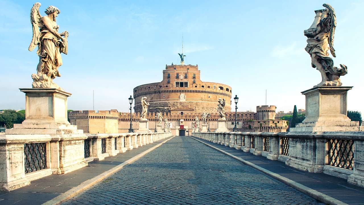 Castel Sant'Angelo's façade from street level with a walkway and two angels in front