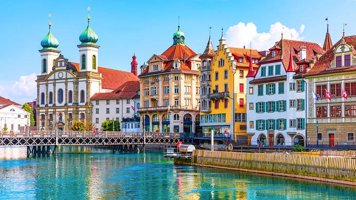 Colorful adjacent buildings near a bridge over a river