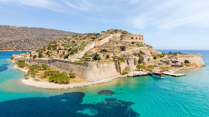 A large fortress on an island surrounded by clear waters