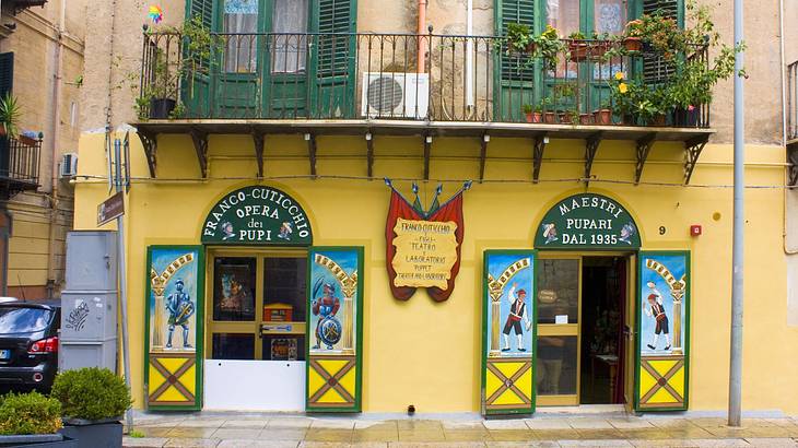 A facade of a shop with colorful doors and windows