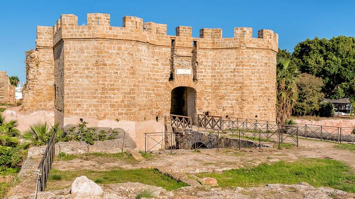 Ruins of an old bricked fortress with a bridge on a sunny day