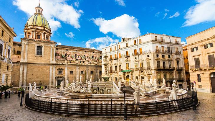 A circular fountain surrounded by old buildings