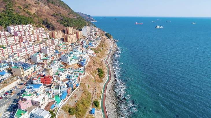 A village with many colorful houses on mountainous terrain near the sea