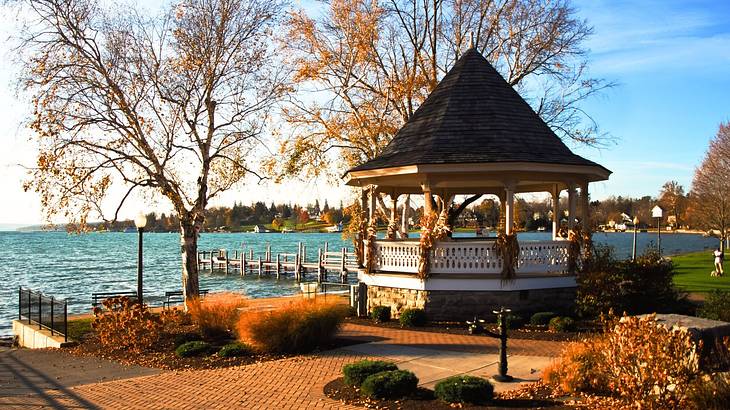 A small park with a gazebo overlooking the water with a walkway around it