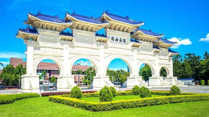 The main gate of the Taiwan Democracy Memorial Hall in Taipei behind green grass