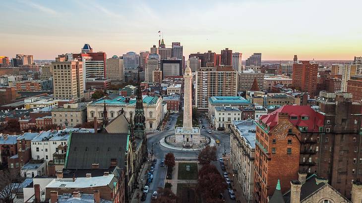 Aerial shot of a city with an obelisk in the middle