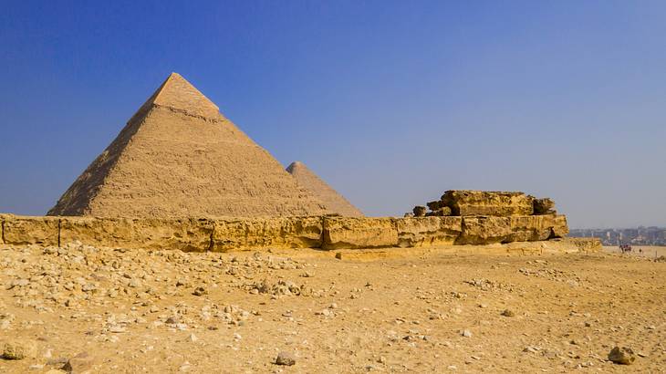 Pyramids of Giza and a funerary temple on the side on a clear blue day