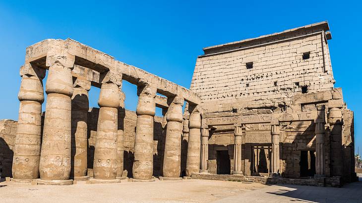 An ancient Egyptian temple with its massive columns on a sunny day
