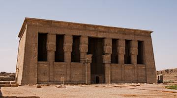 Full view of a grand Egyptian temple with ancient carvings on its exterior