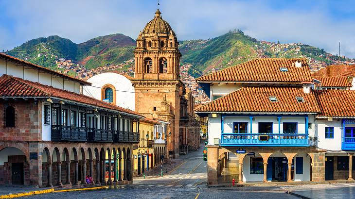 Empty roads surrounded by old houses with tiled roofs and an old cathedral