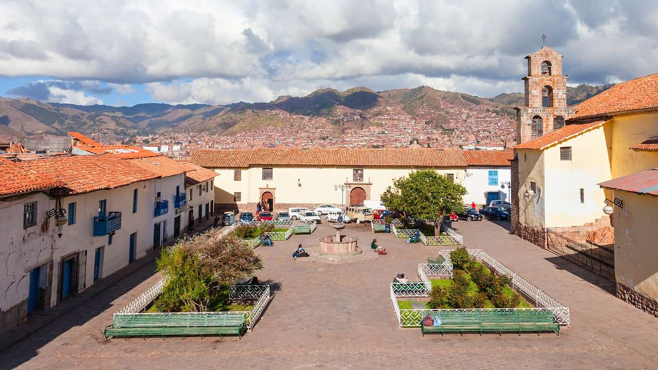 Aerial shot of an open area surrounded by old buildings with tile roofs