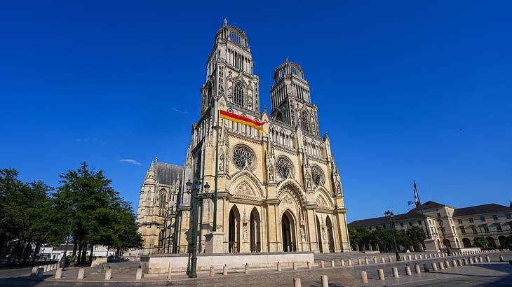 A low-angle shot of an old cathedral with two bell towers