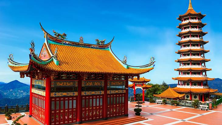 A temple and pagoda standing side by side overlooking mountains A temple and pagoda standing side by side overlooking mountains