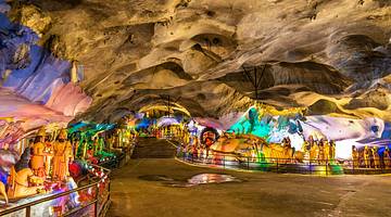 View inside a cave with lights and many colourful sculptures