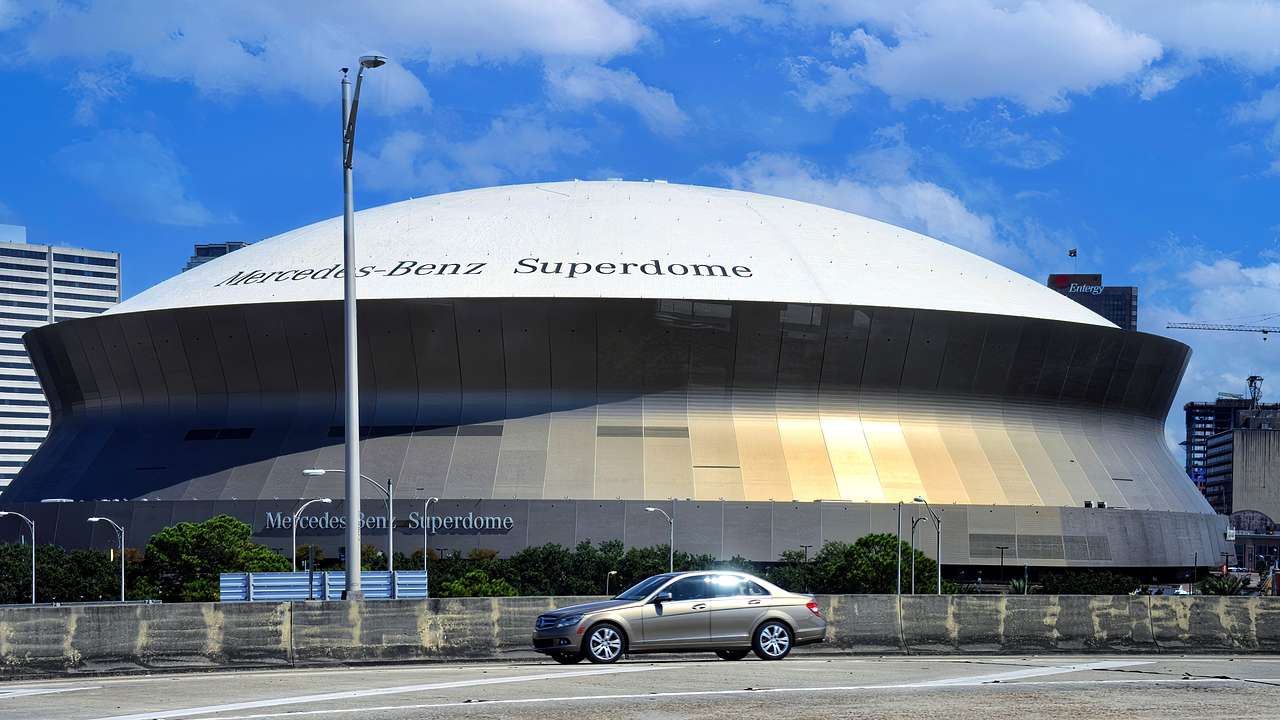 A modern dome-shaped building with a car in front of it