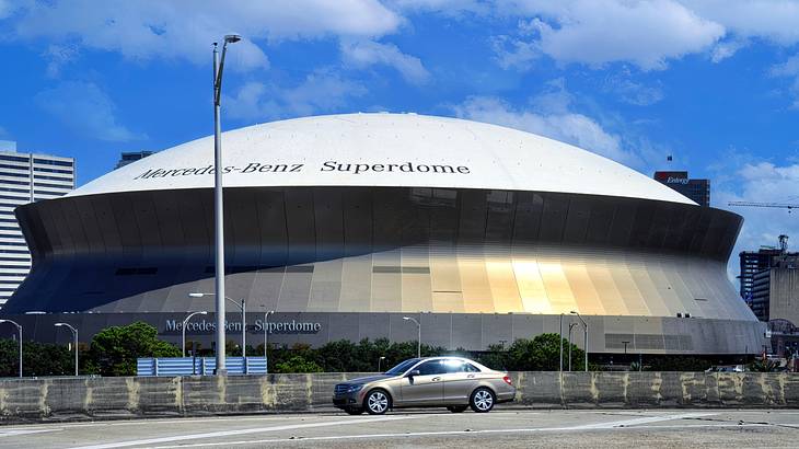 A modern dome-shaped building with a car in front of it