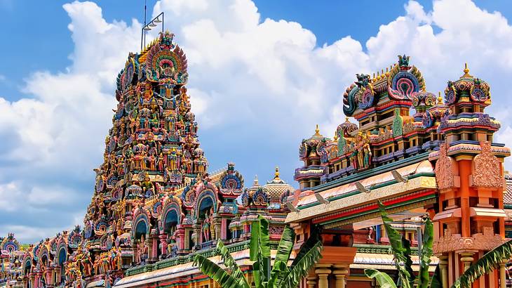 A Hindu temple's intricate rooftop filled with colourful deity statues