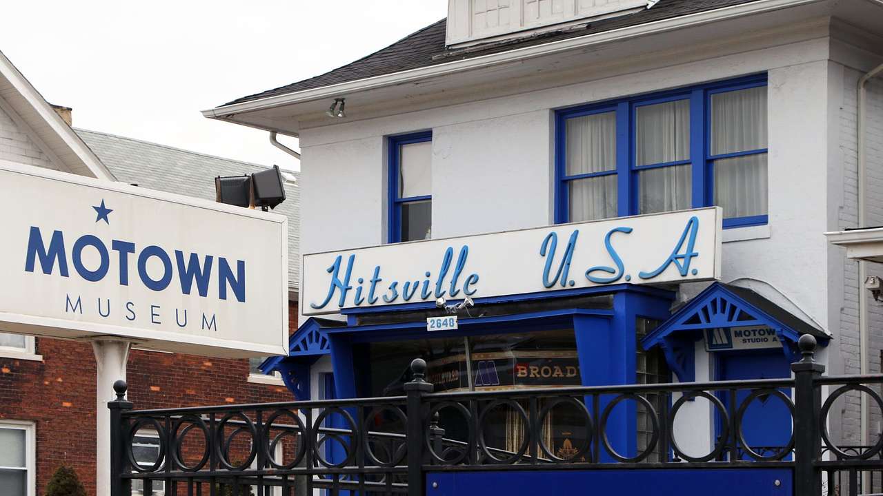 A white and blue house with signs saying "Motown Museum" and "Hitsville USA"