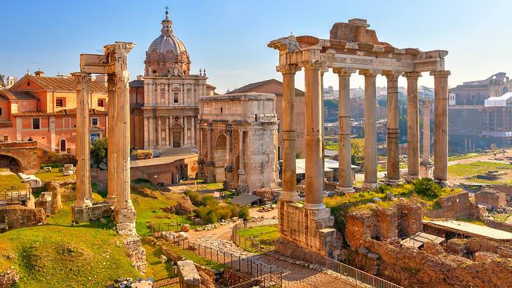 Giant archaeological ruins surrounded by greenery and a blue sky