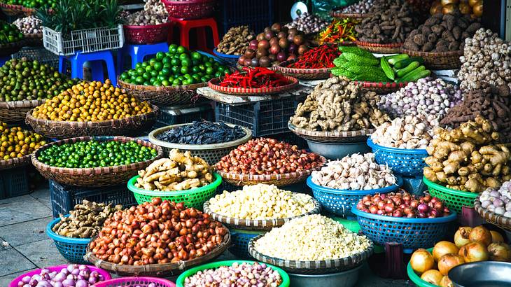 A market stall with lots of vegetables in baskets