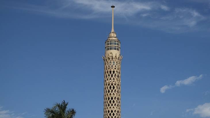 The top of the Cairo Tower against a blue sky