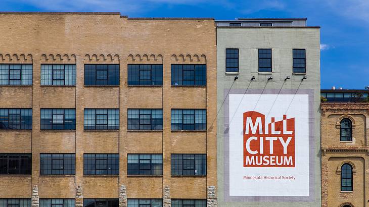 A building with many windows and a red sign that says "Mill City Museum"