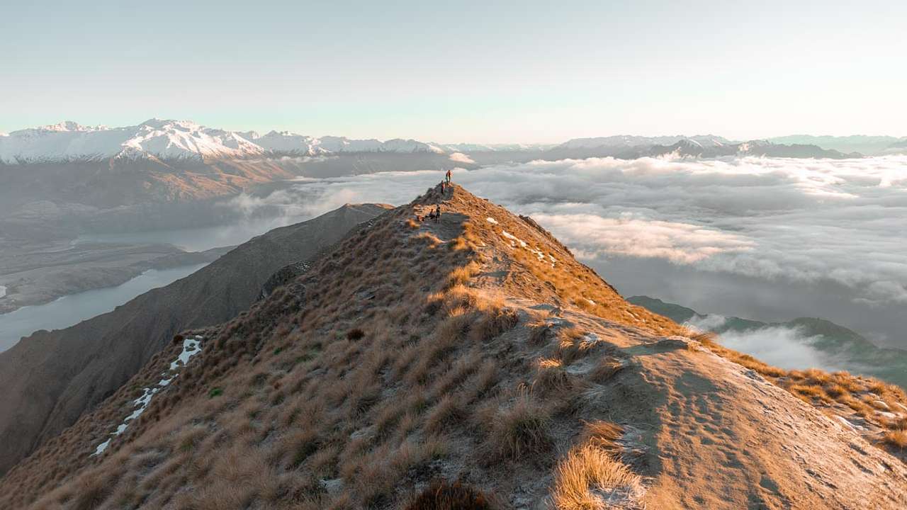 View from above the clouds of people at a mountaintop lookout