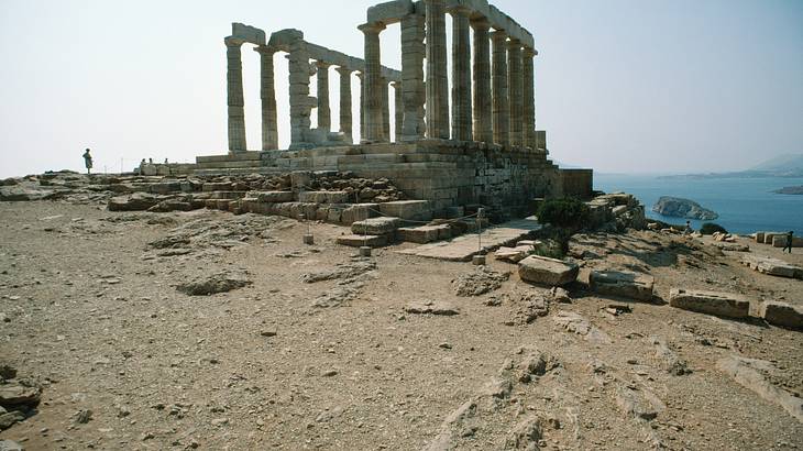 Temple of Poseidon overlooking the cliffs at Cape Sounion in Greece