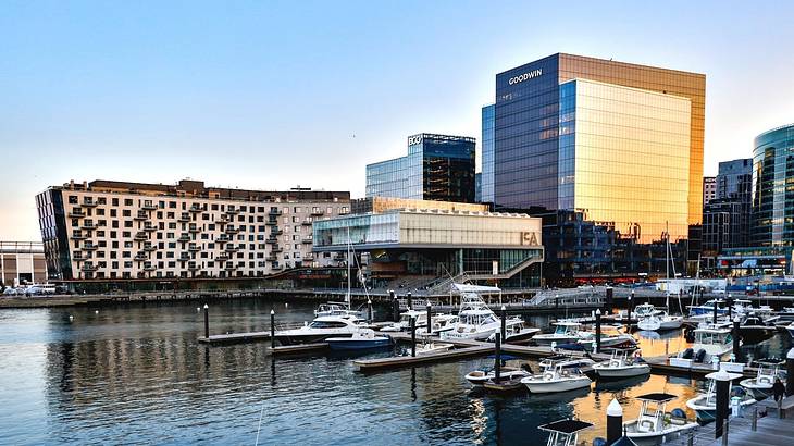 A modern building with a harbor and boats in front of it