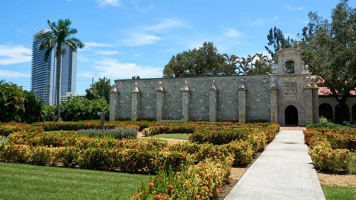 A stone monastery structure with a path and garden in front of it