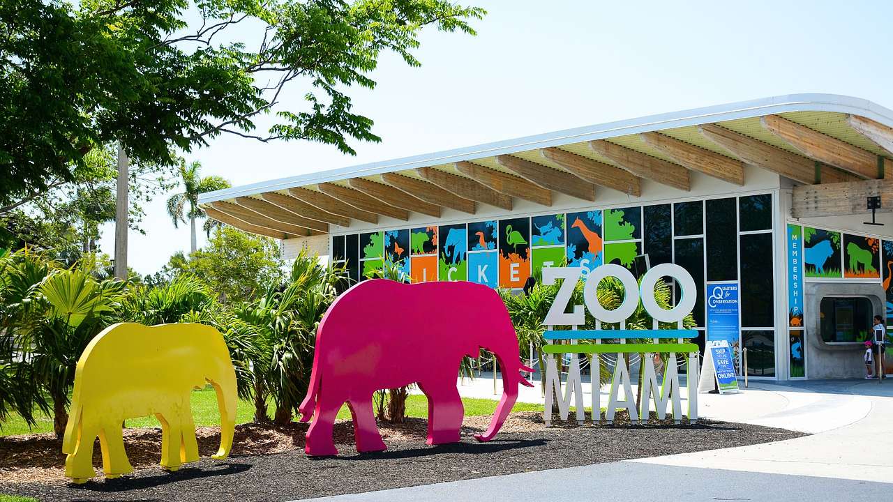 A building with two elephant sculptures and a "Zoo Miami" sign