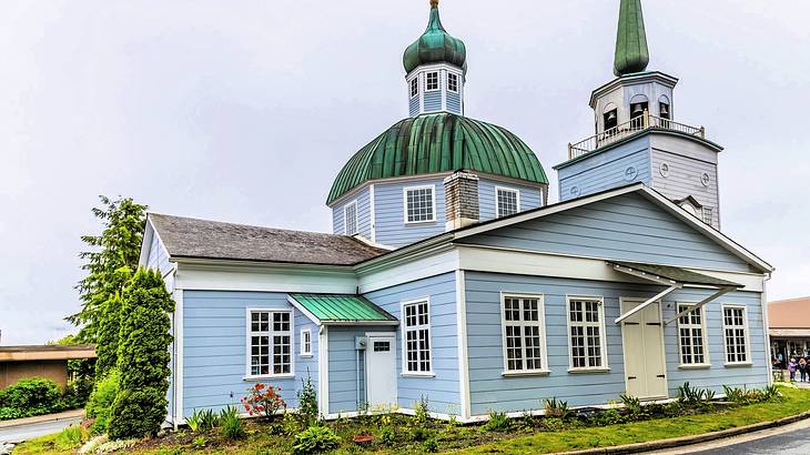 A blue house with windows, a dome top, and spires