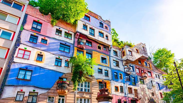 A colourful apartment building with trees integrated into the design