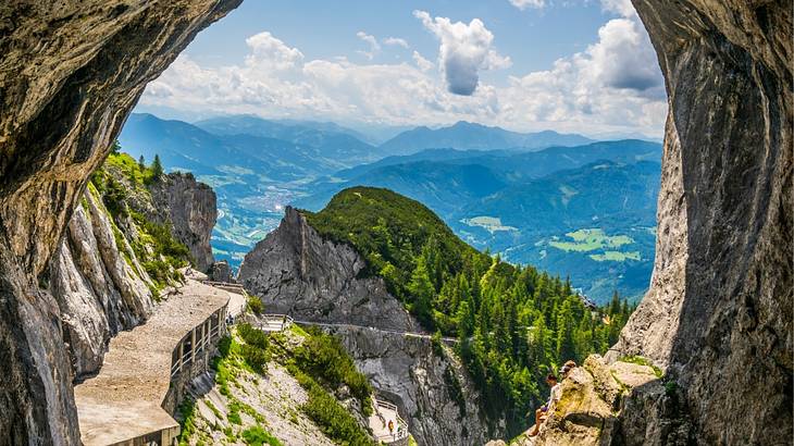 A view over rocks and mountains under a blue sky with clouds