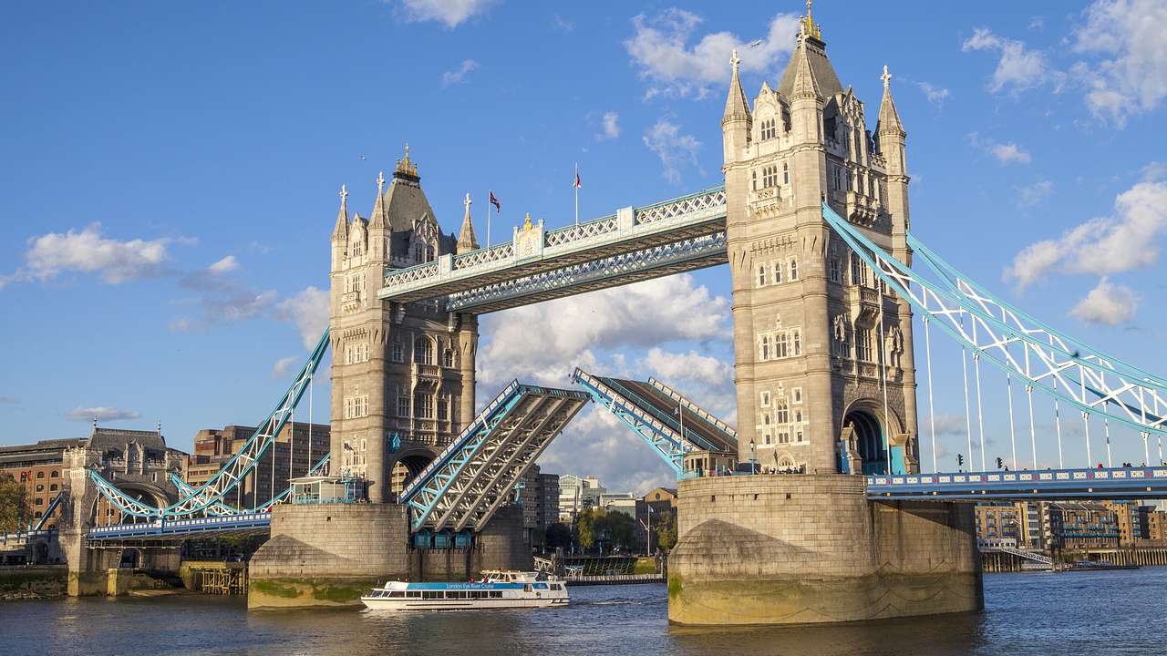 A bridge with two towers and its drawbridges raised to let boats through