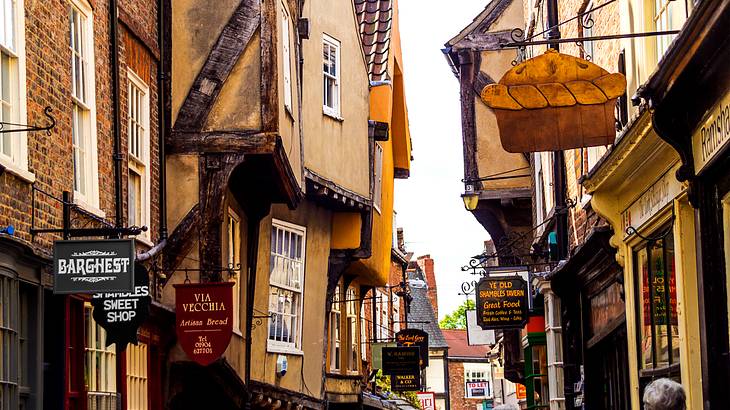 An old medieval street full of buildings with windows on each side