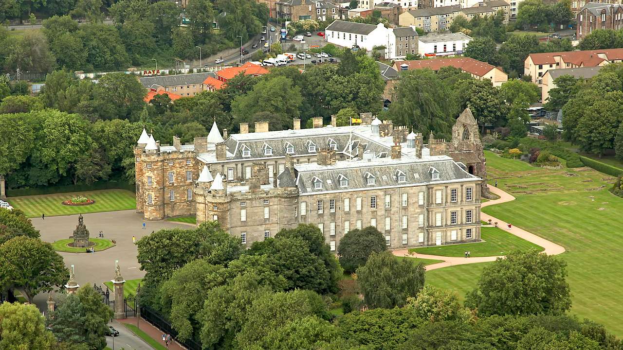 A high-angle view of a palace with trees and buildings at the back