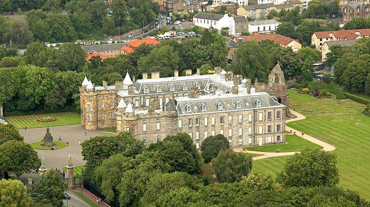 A high-angle view of a palace with trees and buildings at the back