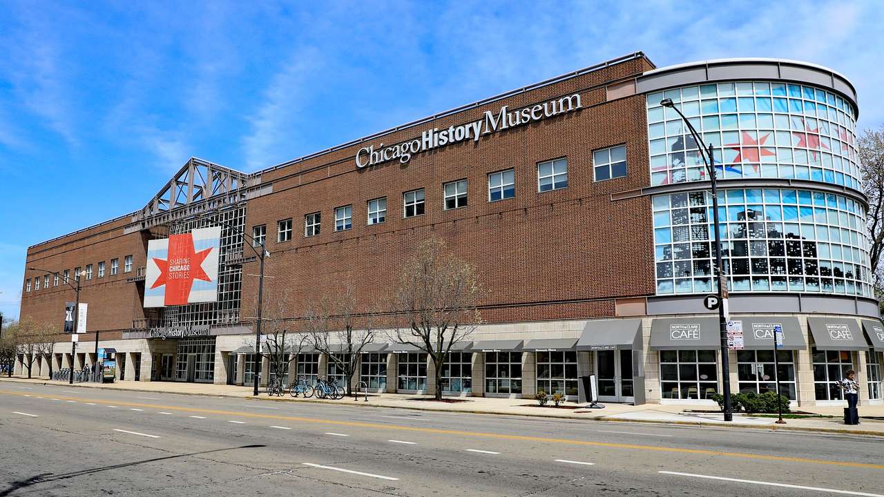 A brick building with glass windows and a "Chicago History Museum" sign